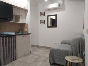a kitchen with a chair and a mirror on the wall at Gomez City Centre in Málaga