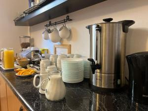 eine Küche mit einer Arbeitsfläche mit Tellern und einer Kaffeemaschine in der Unterkunft Hotel Amelie Berlin in Berlin