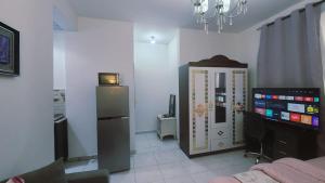 a living room with a television and a refrigerator at Harmonic properties in Abu Dhabi