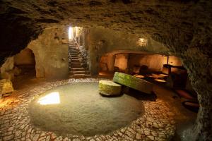 a cave with a bench in the middle of a tunnel at Borgo Mulino a Vento - Resort in Uggiano la Chiesa +76 photos
