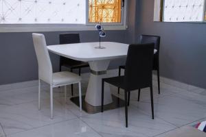 a white table and chairs in a room at Blue Breeze in Luanda