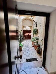 an open door to a room with potted plants at Mary Apt - Historical Residence- Lecce in Lecce