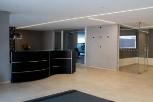 a living room with a clock on the wall and a room at Marisabella Suite Spa 4 in Bari