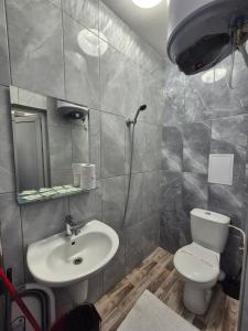 a bathroom with a toilet and a sink at Студио Лазур с Безплатен Паркинг in Pomorie +8 photos