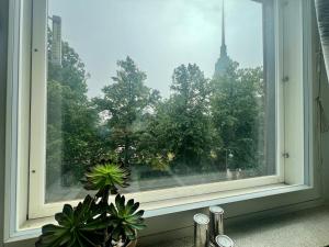 a window with a view of a city at Helsinki Punavuori Studio in Helsinki