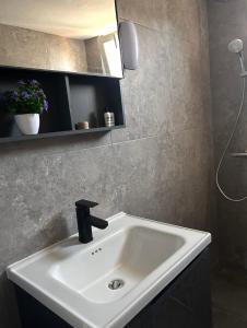 a bathroom with a white sink and a mirror at AVG Studios Preveza in Mytikas +7 photos