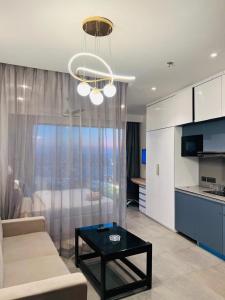 a living room with a couch and a table at Eden Suite - 30th floor in Noida