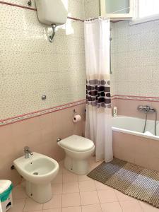 a bathroom with a toilet and a tub and a sink at Mary Apt - Historical Residence- Lecce in Lecce