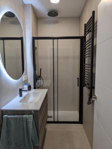 a bathroom with a sink and a shower with a mirror at Cal Ticó, 6 guests Monistrol de Montserrat in Monistrol +15 photos