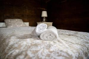 two towels sitting on top of a bed at Siedlisko nad Wieprzem in Kośmin