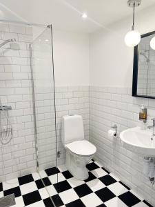 a bathroom with a toilet and a sink at Adas Hotell in Östhammar