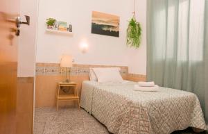 niewielka sypialnia z łóżkiem i stołem z lampką w obiekcie Aire Hostal en Los Alcores w mieście El Viso del Alcor +25 zdjęć