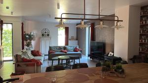 a living room with a couch and a table at Die Alte Linde in Butgenbach