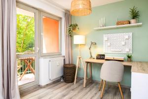 a home office with a desk and a window at StayTime - Canopy Loft in Dresden