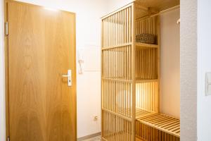 a closet with wooden shelves and a door at StayTime - Canopy Loft in Dresden +8 photos