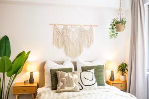 a bedroom with a bed with green and white pillows at StayTime - Canopy Loft in Dresden