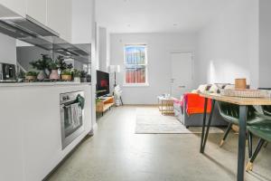 a living room with a table and a fireplace at 2-Bedroom House Hoolloomooloo Good for 6 Guests in Sydney