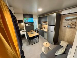 a living room with a couch and a table in a caravan at TJ Escape - Mobile Home in Pakoštane