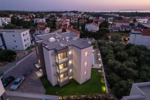 an aerial view of a house in a city at Poolside Hideout Apartments in Novalja