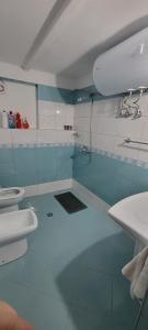 a blue and white bathroom with two toilets at Vila Arbër 7 in Pogradec