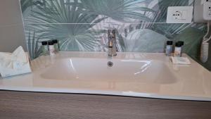 a white sink with a faucet in a bathroom at Al parco1 in Termoli +13 photos