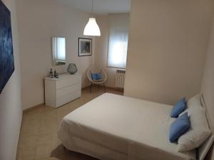 a bedroom with a bed and a chair in it at Nonna Eleonora in Otranto