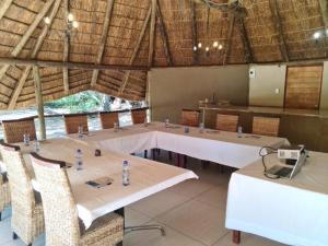 a meeting room with tables and chairs in a building at Lion and Cheetah Sanctuary in Cullinan
