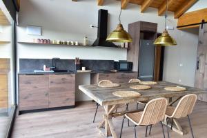 a kitchen with a wooden table and chairs at La Finca del Valle 