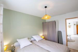 a bedroom with a large bed with white pillows at La belle etoile in Saint-Aulaye +6 photos