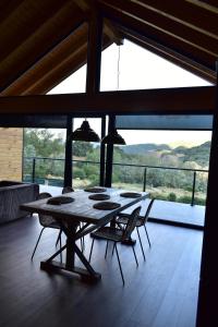 a table in a room with chairs and a large window at La Finca del Valle 