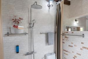 a shower stall in a bathroom with a toilet at Guenia ll in El Mojón +11 photos