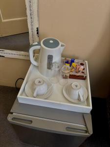 a white coffee maker on top of a shelf at Aerodrome Lodge and Conference Centre in Benoni
