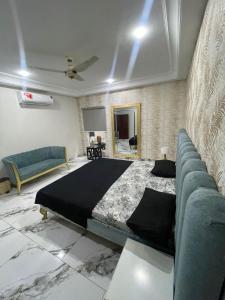 木尔坦Luxury Condo in Central Multan with Self Check-In的带一张大床和一张沙发的卧室