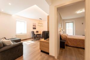 a living room with a bed and a dining room at Casa di Gio in Cavalese