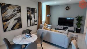 a living room with a couch and a tv at pearl 1bdr apartment in business bay in Dubai
