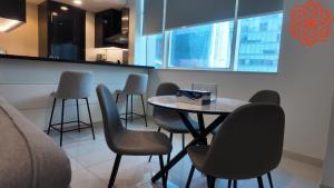 a dining room with a table and some chairs at pearl 1bdr apartment in business bay in Dubai