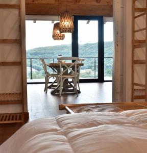 a bedroom with a table and chairs and a balcony at La Finca del Valle  +54 photos