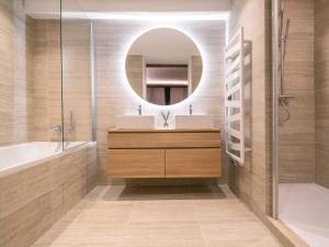 a bathroom with a sink and a mirror at Le Chalet des Amis - Meribel - piscine, ciné, salle de jeux in Méribel +32 photos