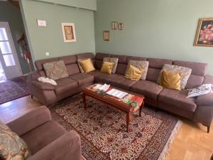 a living room with a couch and a coffee table at Holiday Home Ilidza Rose in Sarajevo