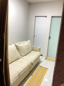 a couch in a room with two glass doors at Cacau estadia in Canindé de São Francisco