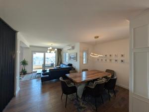 a living room with a wooden table and chairs at Penthouse NIKOLA in Budva