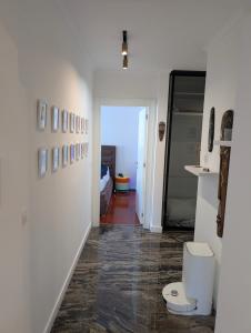 a hallway with a toilet in a room at Penthouse NIKOLA in Budva +23 photos
