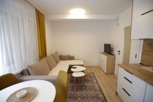 a living room with a couch and a table at Apartman Centar in Fojnica