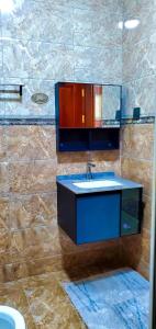 a bathroom with a sink and a mirror at Ayan homes in Namulanda