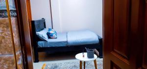 a small room with a bed and a small table at Ayan homes in Namulanda