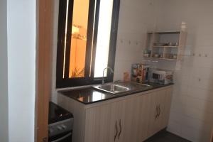 a small kitchen with a sink and a window at Appartement aux Mamelles in Dakar +10 photos