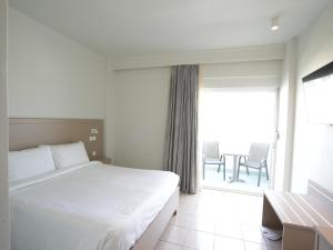 Posteľ alebo postele v izbe v ubytovaní AGRELLI Hotel & Suites