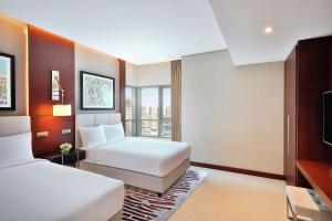 Ένα ή περισσότερα κρεβάτια σε δωμάτιο στο Hilton Doha The Pearl