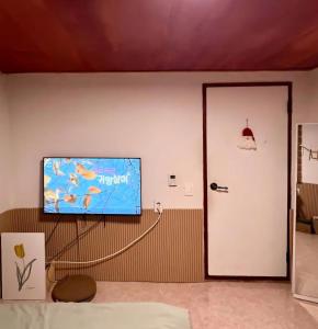 a living room with a flat screen tv on the wall at Itaewon Namsan View Rooftop in Haebangchon in Seoul