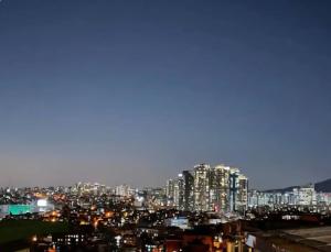 a view of a city skyline at night at Itaewon Namsan View Rooftop in Haebangchon in Seoul